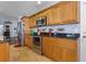 Bright kitchen featuring stainless steel appliances, tile backsplash and wood cabinets at 11126 Oakshore Ln, Clermont, FL 34711