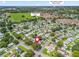 Aerial view of the property with a neighborhood pool, close to Lake Sumter Landing Market Square and open green spaces at 1202 Del Toro Dr, Lady Lake, FL 32159