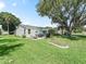 Spacious backyard featuring a patio with an outdoor dining area, perfect for entertaining and relaxation at 1202 Del Toro Dr, Lady Lake, FL 32159