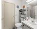 A bathroom featuring a toilet, a sink with cabinet and a mirror with lights above at 1202 Del Toro Dr, Lady Lake, FL 32159