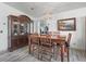 Elegant dining room featuring a classic china cabinet, a modern chandelier, and comfortable seating for six at 1202 Del Toro Dr, Lady Lake, FL 32159