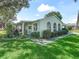 Well-maintained single-story home with manicured landscaping and inviting curb appeal, offering a serene ambiance at 1202 Del Toro Dr, Lady Lake, FL 32159