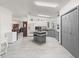 Spacious kitchen with white and gray cabinets, tile floors, and modern appliances at 1202 Del Toro Dr, Lady Lake, FL 32159