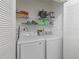 A laundry room featuring a washer, a dryer, and shelving for storage at 1202 Del Toro Dr, Lady Lake, FL 32159