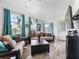 Bright and airy living room boasting stylish decor, large windows, and wood-look floors at 1202 Del Toro Dr, Lady Lake, FL 32159