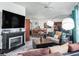 Cozy living room with a fireplace, seamlessly connected to the dining area, offering a comfortable living space at 1202 Del Toro Dr, Lady Lake, FL 32159