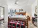 Bright bedroom featuring a wooden bed frame, large windows, and cozy decor at 1202 Del Toro Dr, Lady Lake, FL 32159