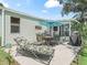 A backyard patio offers dining and lounge furniture, perfect for outdoor relaxation and entertaining at 1202 Del Toro Dr, Lady Lake, FL 32159