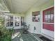 Inviting screened-in porch with outdoor seating, creating a cozy and functional entrance to the home at 1202 Del Toro Dr, Lady Lake, FL 32159