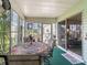 A sunroom with lots of light, a round table and decorative chairs at 1202 Del Toro Dr, Lady Lake, FL 32159