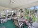 A sunroom with lots of light, a round table and decorative chairs at 1202 Del Toro Dr, Lady Lake, FL 32159