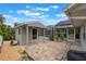 Backyard featuring a storage shed, a screened-in pool area, and a brick patio at 12401 Blue Heron Way, Leesburg, FL 34788