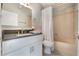 The bathroom has a shower and tub combination, tiled floor, and a stone countertop at 12401 Blue Heron Way, Leesburg, FL 34788