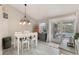 Bright dining room with views of the screened lanai at 12401 Blue Heron Way, Leesburg, FL 34788