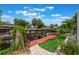 Exterior view of a covered boat dock on a canal, featuring artificial turf and brick pavers at 12401 Blue Heron Way, Leesburg, FL 34788