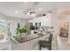 Modern eat-in kitchen featuring stainless appliances, stylish pendant lights, and a breakfast bar at 12401 Blue Heron Way, Leesburg, FL 34788