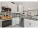 Well-appointed kitchen with stainless steel appliances, ample counter space, and tile backsplash at 12401 Blue Heron Way, Leesburg, FL 34788
