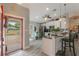 Bright and airy kitchen featuring stainless steel appliances, counter seating, and plenty of natural light at 12401 Blue Heron Way, Leesburg, FL 34788