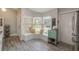 Cozy kitchen nook with bright windows, bench seating and luxury vinyl flooring at 12401 Blue Heron Way, Leesburg, FL 34788