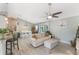 Inviting living area with an open layout, seamlessly connecting the kitchen and dining spaces at 12401 Blue Heron Way, Leesburg, FL 34788