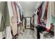 Spacious walk-in closet featuring built-in shelving and a mirror, providing ample storage at 12401 Blue Heron Way, Leesburg, FL 34788