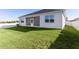 Spacious backyard with screened patio and lush green grass at 12624 Ne 49Th Dr, Oxford, FL 34484