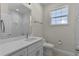 Bathroom with a white vanity, stylish fixtures, and decorative wall accents at 12624 Ne 49Th Dr, Oxford, FL 34484