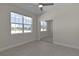 Bedroom featuring a ceiling fan, large window, and closet at 12624 Ne 49Th Dr, Oxford, FL 34484