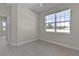Cozy bedroom features light tile flooring and natural lighting at 12624 Ne 49Th Dr, Oxford, FL 34484