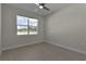 Bright bedroom featuring a large window and modern ceiling fan at 12624 Ne 49Th Dr, Oxford, FL 34484
