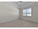 Bright bedroom featuring a large window and neutral tones at 12624 Ne 49Th Dr, Oxford, FL 34484