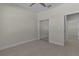 Neutral bedroom boasts a mirrored closet and tile flooring at 12624 Ne 49Th Dr, Oxford, FL 34484