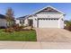 Charming single-Gathering home featuring a well-manicured lawn and a brick paved driveway leading to a two-car garage at 12624 Ne 49Th Dr, Oxford, FL 34484