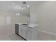 Bright and open kitchen featuring stainless steel appliances, an island with sink, and white cabinets at 12624 Ne 49Th Dr, Oxford, FL 34484