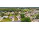 A high angle shot shows a community with trees, manicured lawns and landscaping at 12687 Se 90Th Ter, Summerfield, FL 34491