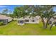 Large backyard with mature trees surrounding the house, plus a screened-in lanai at 12687 Se 90Th Ter, Summerfield, FL 34491