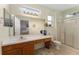 Bright bathroom featuring a spacious vanity, large mirror, and a glass-enclosed shower at 12687 Se 90Th Ter, Summerfield, FL 34491