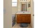 Bathroom featuring tiled flooring, oak vanity with white countertop, and large mirror at 12687 Se 90Th Ter, Summerfield, FL 34491
