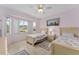 Bright bedroom features twin beds, tile floor, a ceiling fan and large windows at 12687 Se 90Th Ter, Summerfield, FL 34491