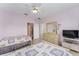 Relaxing bedroom with twin beds, tile flooring and ceiling fan at 12687 Se 90Th Ter, Summerfield, FL 34491