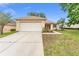 A well-maintained one story home with a two car garage and a lovely front yard at 12687 Se 90Th Ter, Summerfield, FL 34491
