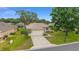 Charming single-Gathering home showcasing a well-manicured lawn and an attached two-car garage at 12687 Se 90Th Ter, Summerfield, FL 34491