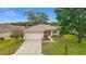 Well-maintained single-story home with a two-car garage, complemented by lush landscaping at 12687 Se 90Th Ter, Summerfield, FL 34491