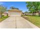 A charming one-story home featuring a two-car garage and well-manicured front yard at 12687 Se 90Th Ter, Summerfield, FL 34491