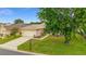 Residential house featuring a well-kept lawn, driveway, and attached two-car garage at 12687 Se 90Th Ter, Summerfield, FL 34491