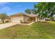 Charming single-story home featuring a well-manicured lawn, two-car garage, and landscaped flowerbeds at 12687 Se 90Th Ter, Summerfield, FL 34491