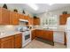 Bright kitchen features lots of light, tile floors, oak cabinets and white appliances at 12687 Se 90Th Ter, Summerfield, FL 34491