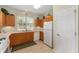 Bright kitchen with tile floors, white appliances, and ample oak cabinets at 12687 Se 90Th Ter, Summerfield, FL 34491