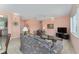 Comfortable living room with tile floors, neutral paint, floral sofa, and window at 12687 Se 90Th Ter, Summerfield, FL 34491