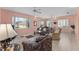 Expansive living room featuring plenty of natural light, tile floors, and comfortable seating at 12687 Se 90Th Ter, Summerfield, FL 34491